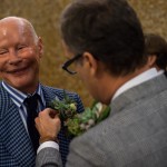 Documentary unique wedding NYC Same Sex Couple pinning flowers, Steve Giovinco