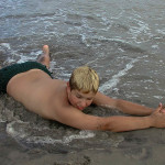 Fine art editorial photography commission, boy laying on beach, NYC, Steve Giovinco