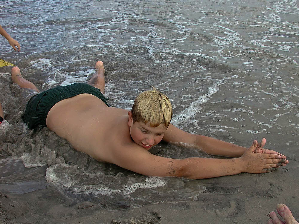 Fine art editorial photography commission, boy laying on beach, NYC, Steve Giovinco
