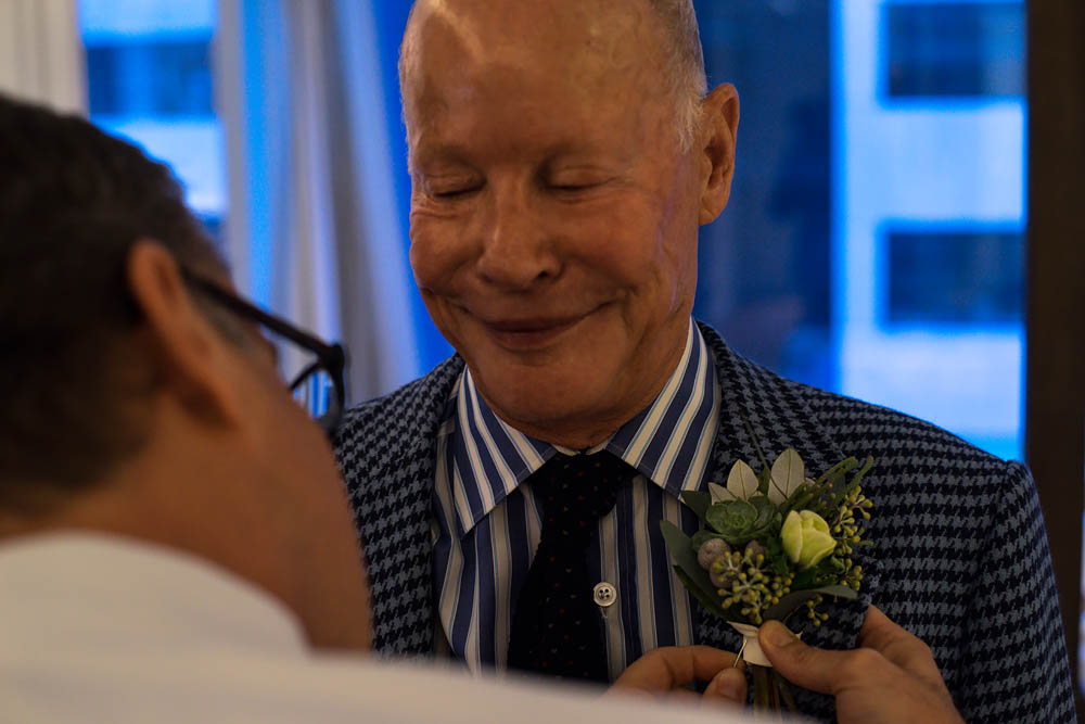 Fine art wedding documentary photography pinning flower in NYC, Steve Giovinco
