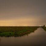 Sites at Risk of Climate Change: Night Landscape Photographs in The Netherlands, Steve Giovinco, Canal, Nieuw Land National Park, with Light in Distance, Flevoland