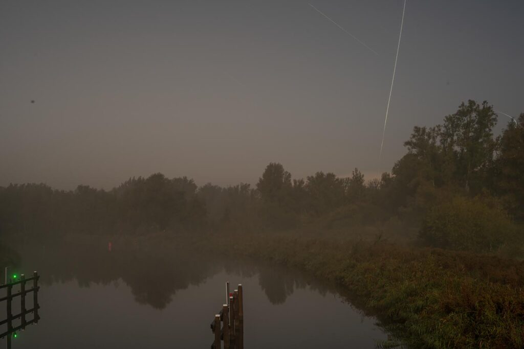 Sites at Risk of Climate Change: Night Landscape Photographs in The Netherlands, Steve Giovinco, Nieuw Land National Park, Locks in Fog with Plane Light in Sky, Frevoland