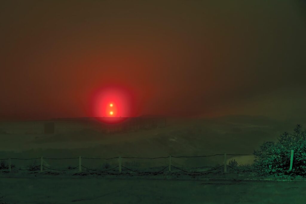 Shadow and Light: New Night Landscape Photographs of Greenland By Steve Giovinco. Red Glowing Light in Fog